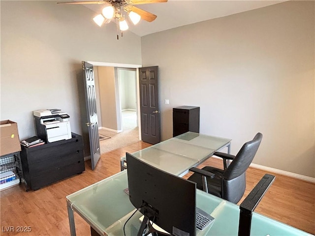 home office with light wood-type flooring, ceiling fan, and baseboards