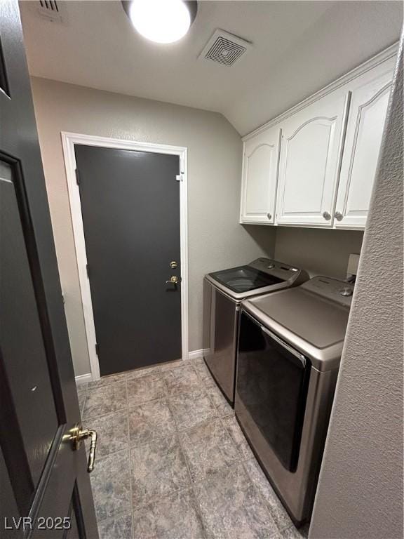 clothes washing area with cabinet space, baseboards, visible vents, and washer and dryer