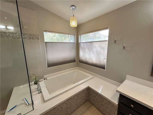 full bathroom with vaulted ceiling, tile patterned flooring, tiled shower, and a garden tub
