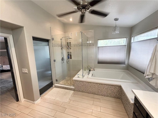 bathroom with a stall shower, lofted ceiling, vanity, and a bath