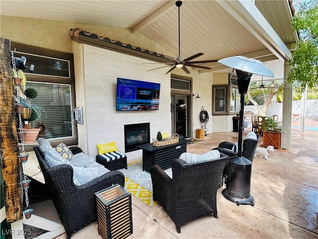 view of patio / terrace with fence, an outdoor living space, and a ceiling fan