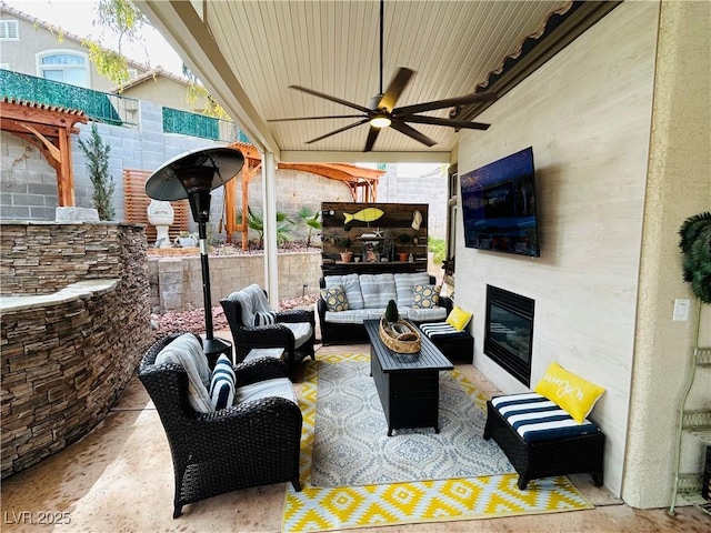 view of patio featuring a ceiling fan and an outdoor living space