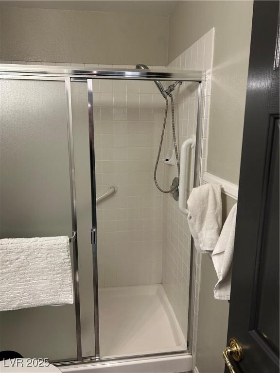 full bath featuring a shower stall