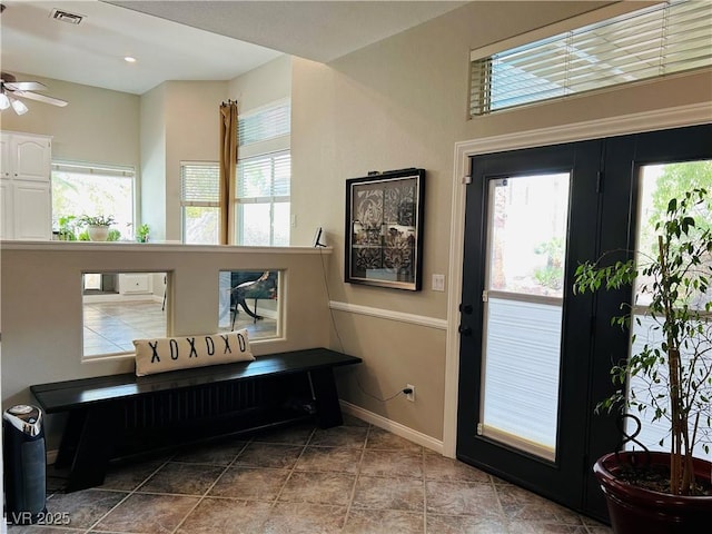 entrance foyer with a healthy amount of sunlight, visible vents, and baseboards