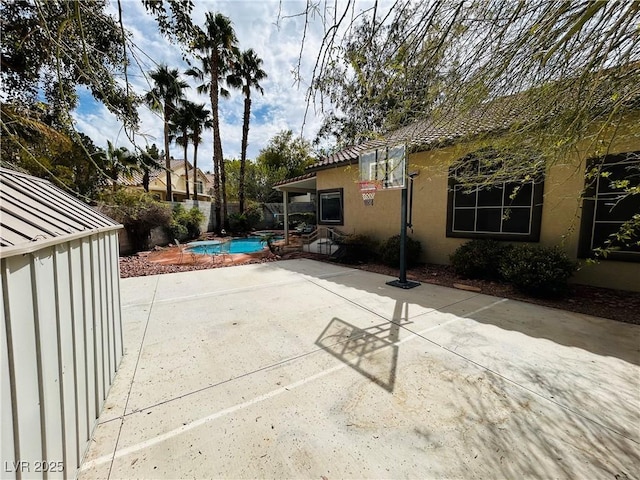 view of patio / terrace with fence and a fenced in pool