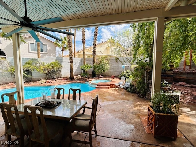 exterior space featuring a pool with connected hot tub, a ceiling fan, outdoor dining space, a patio area, and fence