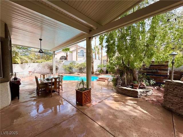 view of patio / terrace with a fenced backyard, a fenced in pool, and outdoor dining space