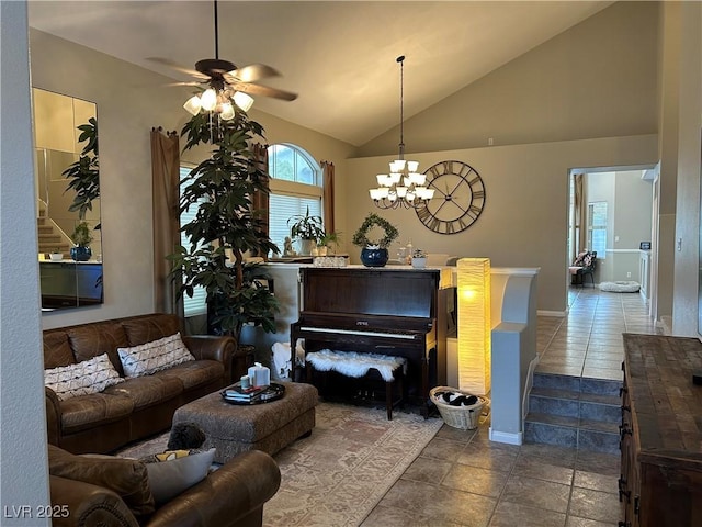 living room with high vaulted ceiling, dark tile patterned flooring, baseboards, and ceiling fan with notable chandelier