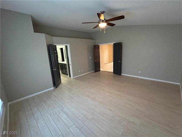 unfurnished bedroom with baseboards, connected bathroom, light wood-style flooring, and ceiling fan