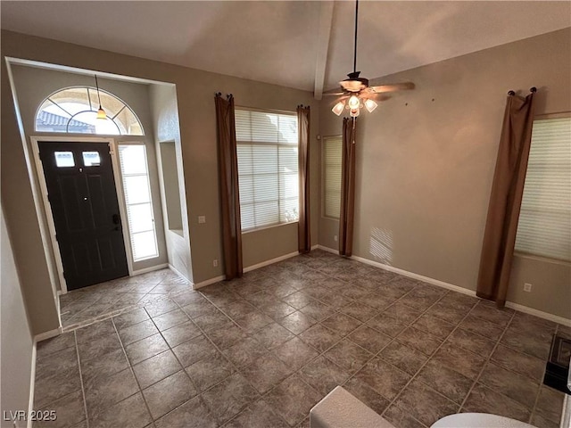 entrance foyer with baseboards, a ceiling fan, and lofted ceiling