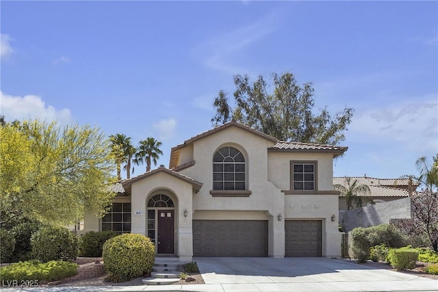 3047 Whispering Crest Dr, Henderson, NV 89052 - mediterranean / spanish-style house featuring a garage, driveway, stucco siding, and a tile roof