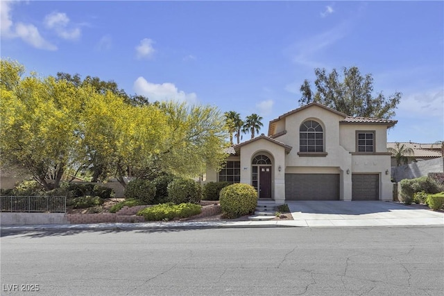 3047 Whispering Crest Dr, Henderson, NV 89052 - mediterranean / spanish house with an attached garage, stucco siding, concrete driveway, and a tiled roof