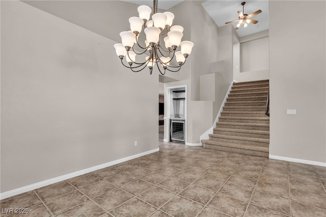 3047 Whispering Crest Dr, Henderson, NV 89052 - unfurnished dining area featuring high vaulted ceiling, stairs, baseboards, a chandelier, and a ceiling fan