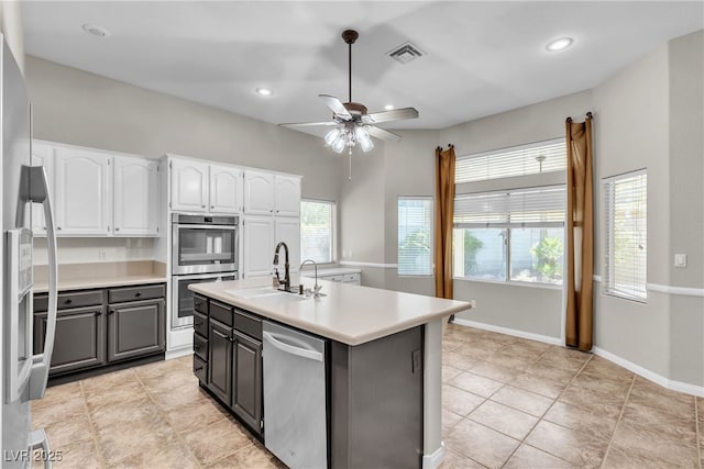 3047 Whispering Crest Dr, Henderson, NV 89052 - kitchen featuring stainless steel appliances, white cabinetry, a sink, a ceiling fan, and light countertops