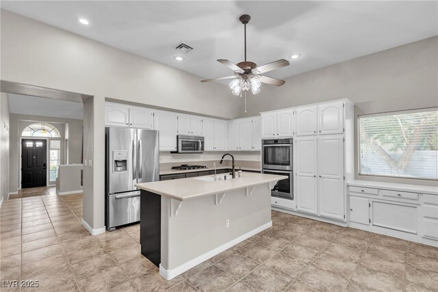 3047 Whispering Crest Dr, Henderson, NV 89052 - kitchen featuring stainless steel appliances, a sink, white cabinetry, light countertops, and a high ceiling