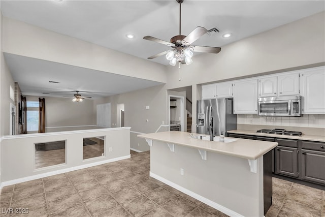 3047 Whispering Crest Dr, Henderson, NV 89052 - kitchen featuring ceiling fan, stainless steel appliances, a sink, light countertops, and white cabinets
