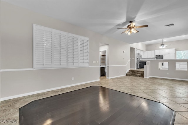 3047 Whispering Crest Dr, Henderson, NV 89052 - unfurnished living room with a ceiling fan, baseboards, and stairway