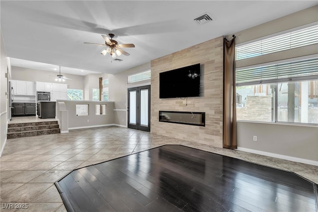 3047 Whispering Crest Dr, Henderson, NV 89052 - unfurnished living room featuring baseboards, ceiling fan, wood finished floors, and a fireplace