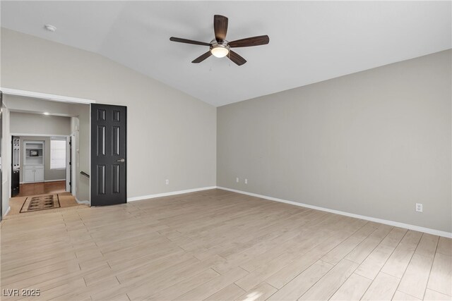 3047 Whispering Crest Dr, Henderson, NV 89052 - spare room with a ceiling fan, lofted ceiling, light wood-type flooring, baseboards, and a smoke detector