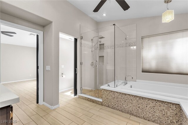 3047 Whispering Crest Dr, Henderson, NV 89052 - bathroom with a ceiling fan, a stall shower, a bath, vanity, and wood finished floors