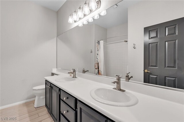 3047 Whispering Crest Dr, Henderson, NV 89052 - bathroom with toilet, double vanity, wood finished floors, baseboards, and curtained shower