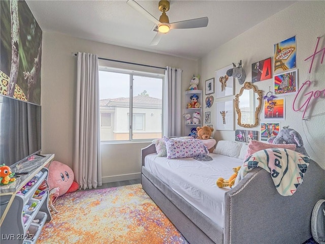 bedroom with wood finished floors, a ceiling fan, and baseboards