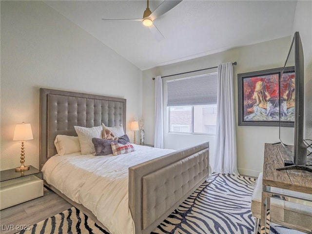 bedroom featuring lofted ceiling, wood finished floors, baseboards, and ceiling fan