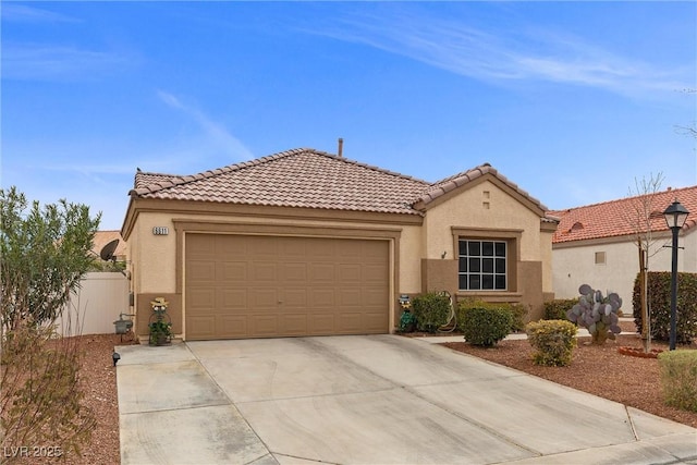 mediterranean / spanish-style home with a garage, fence, concrete driveway, and stucco siding