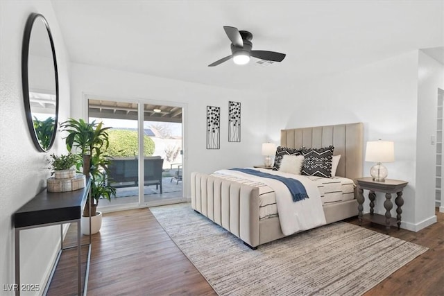 bedroom featuring access to exterior, a ceiling fan, baseboards, and wood finished floors