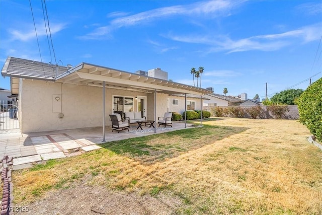 back of house with a patio area, a yard, fence, and stucco siding