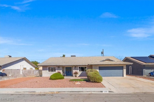 ranch-style home featuring stucco siding, driveway, an attached garage, and fence