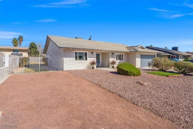 ranch-style house with a gate, fence, an attached garage, and stucco siding