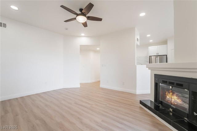 9000 Las Vegas Blvd Unit 1043, Las Vegas, NV 89123 - unfurnished living room with a glass covered fireplace, light wood-style flooring, a ceiling fan, baseboards, and recessed lighting