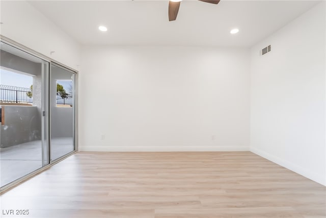 spare room featuring baseboards, light wood-type flooring, visible vents, and recessed lighting