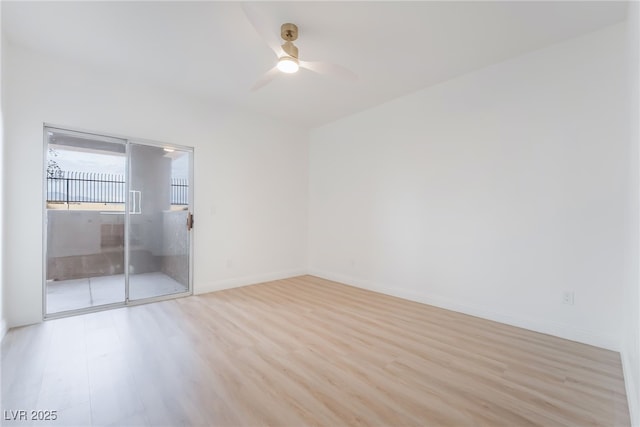 spare room featuring light wood-type flooring, ceiling fan, and baseboards