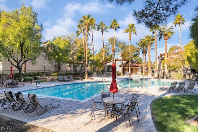 pool featuring fence and a patio