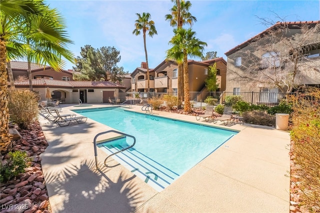 pool featuring a patio area, a residential view, and fence