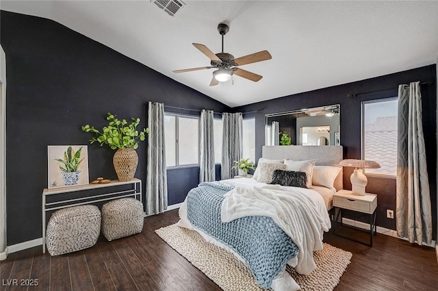 bedroom featuring wood finished floors, visible vents, baseboards, lofted ceiling, and ceiling fan