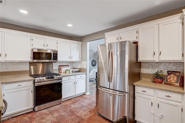 kitchen with light countertops, white cabinets, and stainless steel appliances