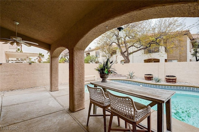 view of patio / terrace featuring outdoor dining space, a fenced in pool, a ceiling fan, and a fenced backyard