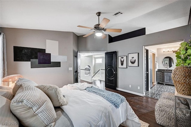 bedroom featuring dark wood finished floors, baseboards, visible vents, and a ceiling fan