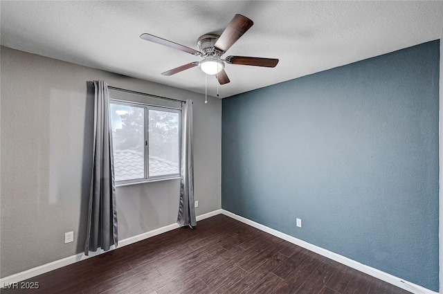 spare room featuring ceiling fan, baseboards, a textured ceiling, and dark wood finished floors