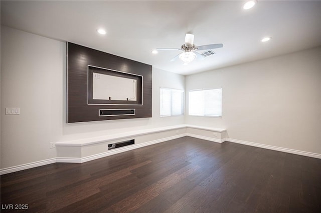 unfurnished room featuring recessed lighting, visible vents, dark wood finished floors, and baseboards