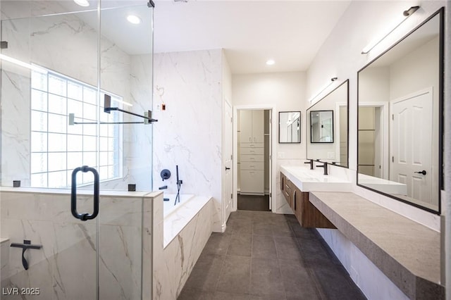 full bath featuring a marble finish shower, a bath, tile patterned floors, vanity, and a closet