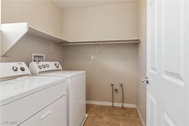 clothes washing area with washer and dryer, laundry area, and baseboards