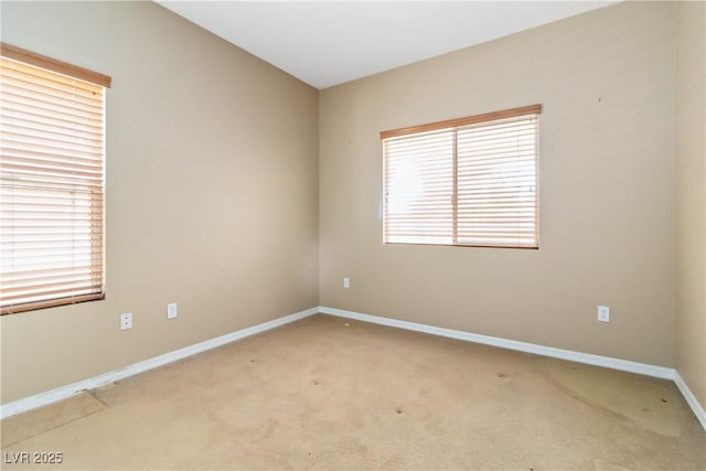 empty room with baseboards and light carpet