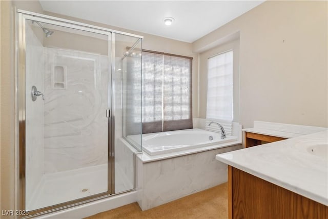 bathroom with vanity, a bath, and a shower stall