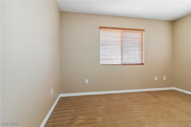 unfurnished room with carpet flooring and baseboards