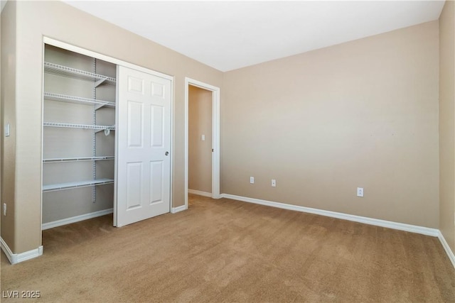 unfurnished bedroom with a closet, baseboards, and carpet floors