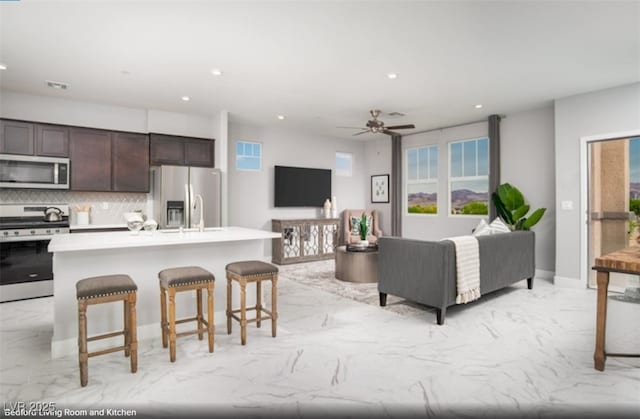 living room featuring ceiling fan, marble finish floor, visible vents, and recessed lighting